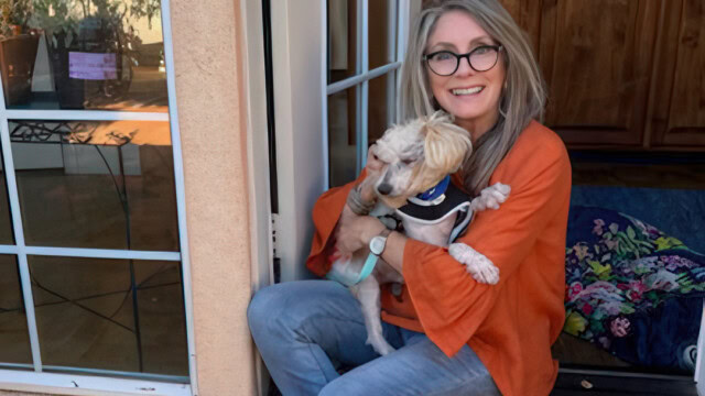 Taj Inayat holding her newly-adopted dog, Snowy